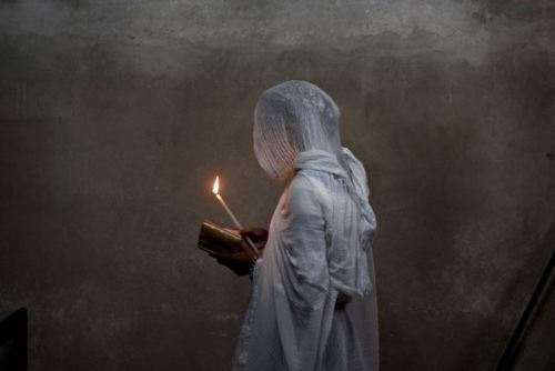 hellonheelz93:An Ethiopian woman prays at Deir el-Sultan Monastery in the Church of the Holy Sepulch