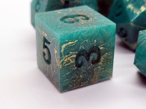 floralprintshark:dicekatdice:Gilded Jade [ID: five photographs of a tabletop gaming dice set lying o