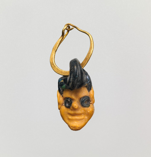 ancientpeoples:Glass head pendant on a gold earringThese pendants were used as protective amulets to