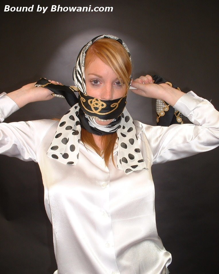 graybandanna:  A headscarfed Fi Stevens gags herself with 2 more scarves 