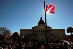 vox:  Wednesday night, a white man walked into a historically black church in Charleston, South Carolina, and shot nine parishioners. Today, a Confederate flag is flying on the grounds of the South Carolina statehouse in Columbia — as it does every