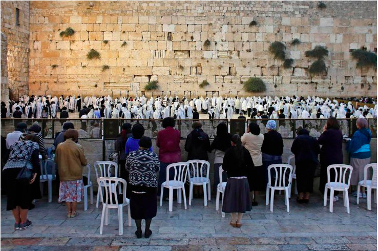 Female Jewish worshippers pray behind the men’s section at the Western Wall, Judaism’s holiest prayer site, in Jerusalem’s Old City ahead of Rosh Hashanah, the Jewish New Year (Photo by Ammar Awad/Reuters via LightBox)