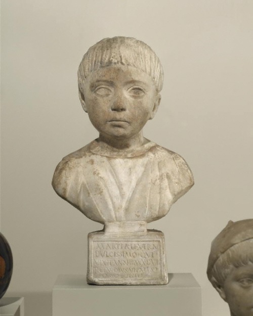 Dedicated as a funerary monument, the marble bust portrays a very young slave child, name Martial, w
