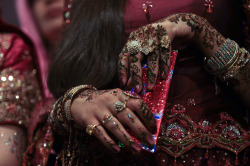 A girl shows her decorated hands during a