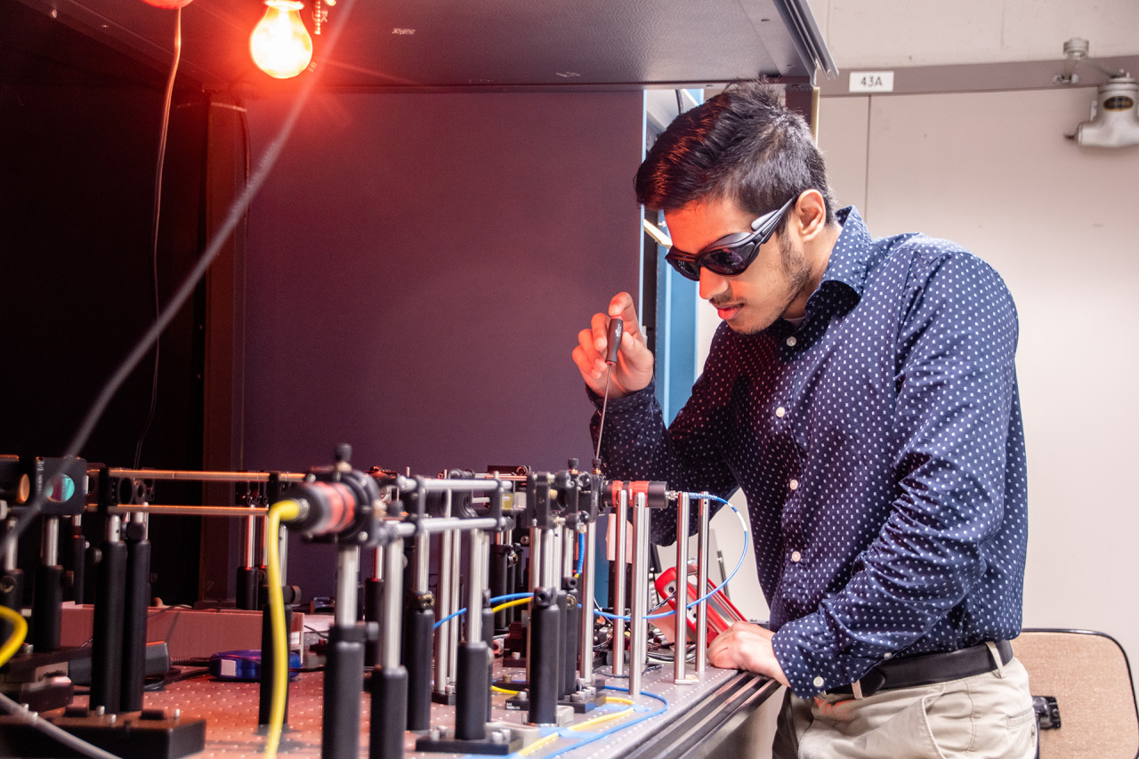 Space Communications and Navigation intern, Ashwin Mishra, testing equipment in the Quantum Communications Lab. Credit: NASA/Glenn Research Center