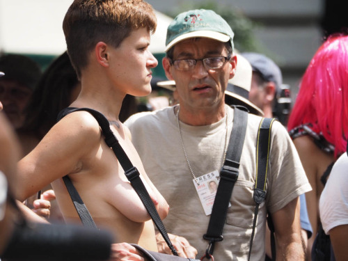 Press photographer makes the shot in Bryant Park after Manhattan’s 2015 National Topless Day Parade.