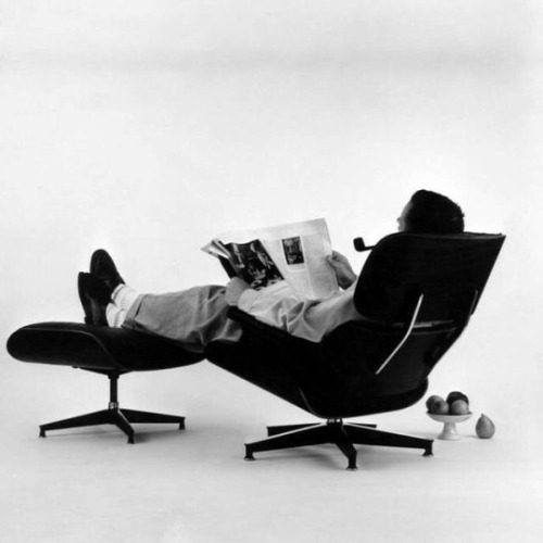 crackheadcouture:Charles Eames in the Eames plywood Lounge Chair and Ottoman, 1956