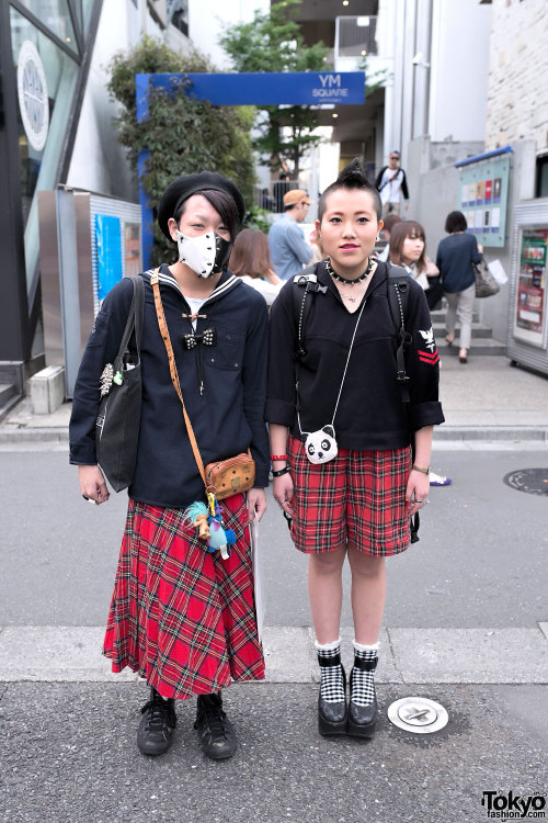 Punky duo Tom & Aimi w/ mohawk, gauged ears, spiky face mask & Sex Pistols bag on the street