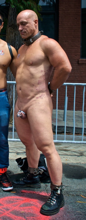 slaveforlabor:  slave with its Owner at 2016 Up Your Alley Street fair, naked, collared, cock locked