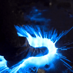 a gif of a foot kicking bioluminescent water around