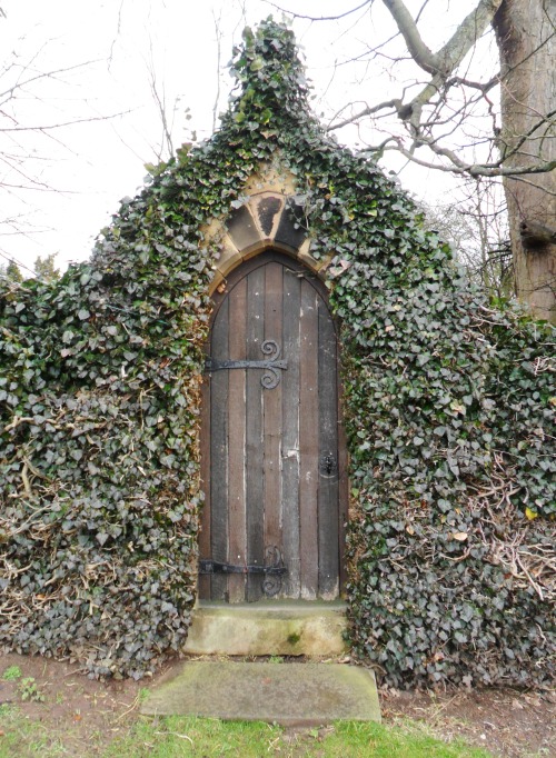 Ornate Ivy overgrown gate at Newstead Abbey. Nottinghamshire, England. 