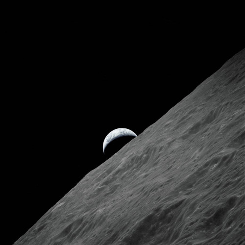 A Picture Of The Crescent Earth As It Rises Above The Lunar Horizon. The Image Was Taken From The Apollo