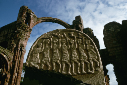 A tombstone decorated with Viking raiders, at Lindisfarne Monastery, Northeast England. News of the 