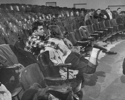 forties-fifties-sixties-love:  A teenage couple in the auditorium of their high school.