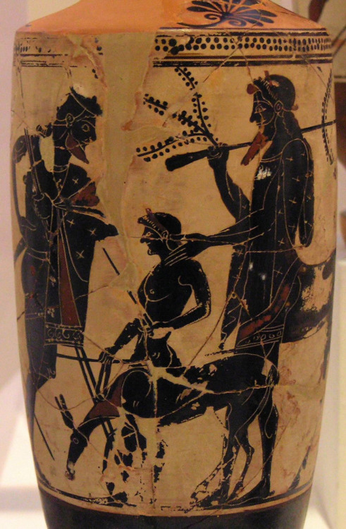 Peleus entrusts his young son Achilles to the care of the centaur Chiron.  White-ground black-figure