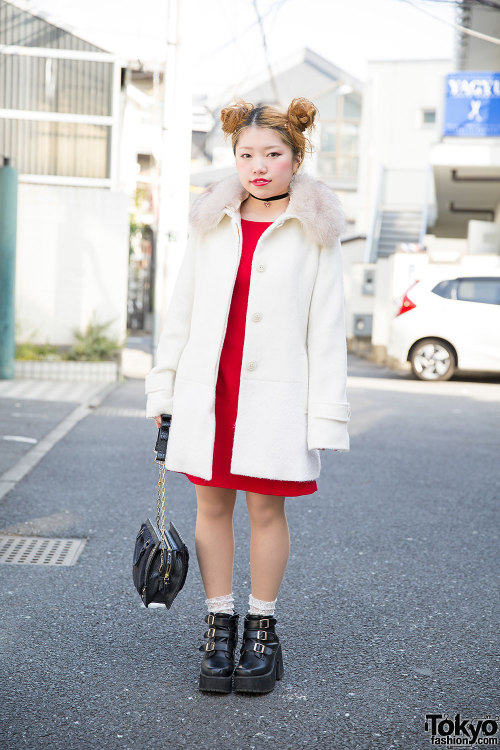 20-year-old Japanese nailist Yuina on the street in Harajuku with a cute twin buns hairstyle, a whit