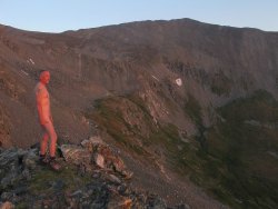 coloradowildboys:  Base Mt. Father Dyer at sunrise; approx 12K ft.Only wearing boots and the sunrise!  Love the colors!  Thanks for the submission!