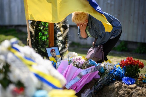 Angela Bondar grieves at the grave of her son, fallen soldier Vladimir Bondar, on May 1, 2022, in Lv