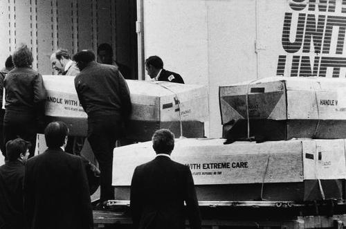 dichotomized:  Men load coffins into a moving truck for transport in Dover, Delaware,