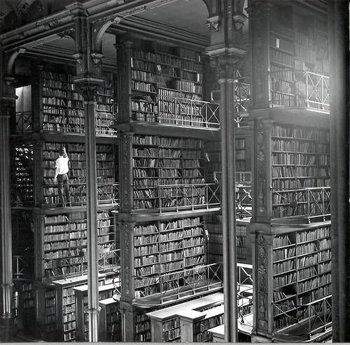 historicaltimes: A man browsing for books in Cincinnati’s cavernous old main library. The libr