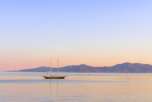 Early morning view with a lonely sailing boat, Mykonos