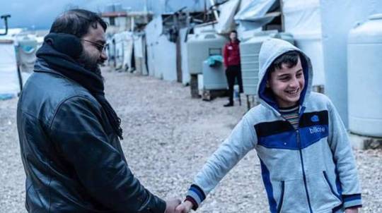islamicrays:  Help for SyriaMeet 11 year old Muhammad. Originally from Syria, currently living in one of those dilapidated shacks in the background in a refugee city in Lebanon. Don’t be fooled by that smile. That beautiful smile hides so many pains.