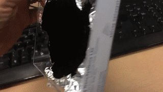 sixpenceee:  Vantablack absorbs so much light that it can fool the eye into seeing a smooth surface on a crumpled sheet of aluminum foil. So on the back you can see that it’s actually crumpled. Isn’t that cool?