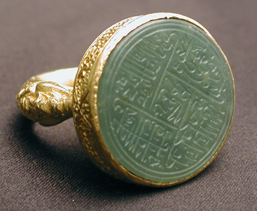 Seal ring with inscription
Iran or Central Asia, late 15th-early 16th century
“ This magnificent gold ring holds a jade stone engraved with religious verses known as the Nad-i ‘Ali, an invocation to 'Ali ibn Abi Talib, son-in-law of the Prophet...