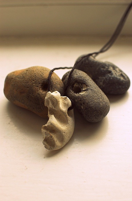 Hag stones. Traditional amulets. Stones with natural holes right through them are considered to be magical, they are thought to make it possible for people to see the spirits in the world and give the owner good luck.