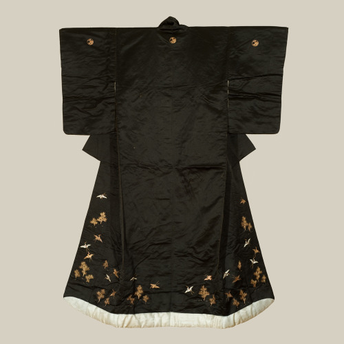 A dramatic black shusu-silk wedding kimono featuring cranes and pines embroidered and couched with m
