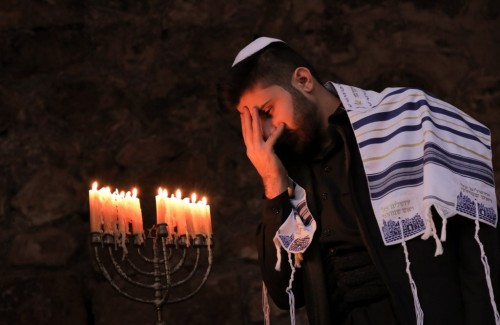 An Iraqi Kurdish Jew takes part in a ceremony on the last night of Hanukkah in the Iraqi town of Alq