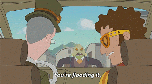 A gif of Cavendish and Dakota in their time vehicle, being attached by Pistachions. Cavendish is struggling to start the car, so Dakota tells him "you're flooding it."