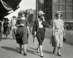 uketeecee:  Flute player, uke player and photographer walking down the street. Circa 1924