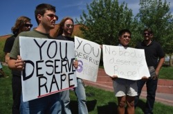 spectorette:  TRIGGER WARNING: RAPE The asshole holding the sign that says You Deserve Rape is Dean Saxton, he attends the University of Arizona and goes by the name of “Brother Dean Samuel&quot;  That’s also him with the racist ass “Ghettopoly&quot;