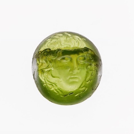 The head of the sleeping Medusa carved in peridot. The Roman made intaglio dates to ca. 1st century 