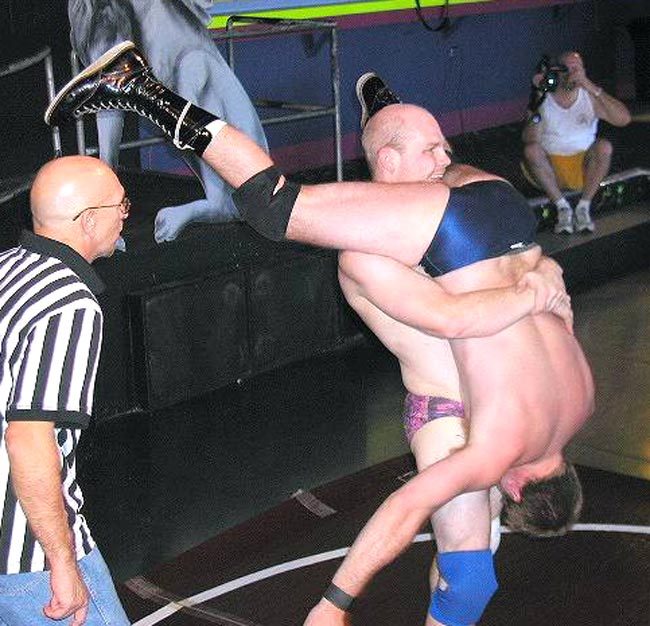 how’s this for my first post…. two real MEN going at it, one dude showing his dominance over the other with a killer illegal outside the ropes piledriver!!! to all of u wimps reading this posting……. that can be U!