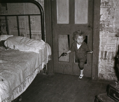 liquidnight:Marion Post Wolcott - Coal miner’s child, holding a pipe in one hand and a gun in the ot