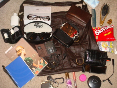 fuckyeahwhatsinyourbag:  oversized bag. matching wallet. striped sunglasses. dior eyeglasses. lens cleaner. contact lens cleaner. hair clip. victoria’s secret berry kiss spray. clinique glosswear. keys w/nyc bottle opener. cough drops. skittles. tissue.