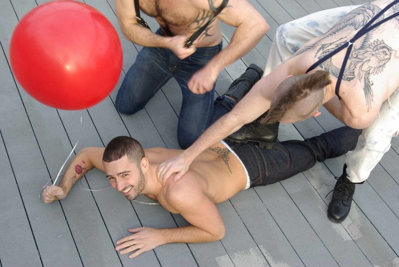 cute stud is attacked by two mohawk tattooed hairy chested dude, determined to beat the cute dude with the balloon