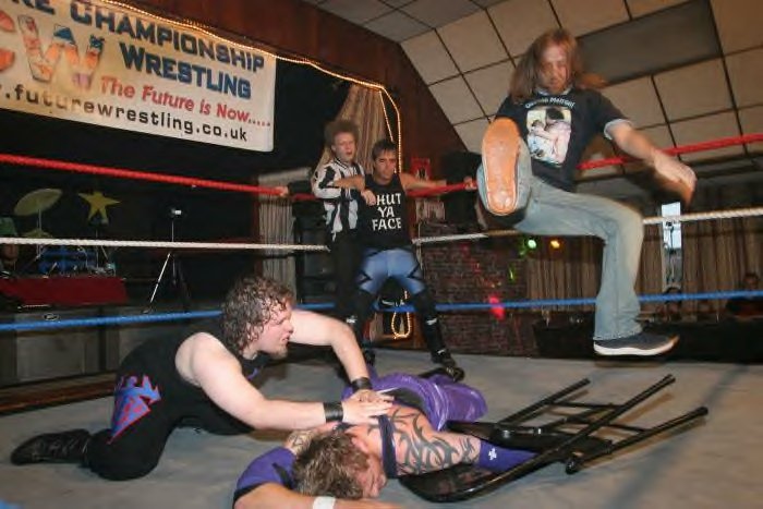 dude in black: bro, i really wanna destroy this punk, i want to make sure he never wrestles again. he tried to make a fool of me. what should we do?
dude in the corner: dude, i’m sure my brother has some ideas. bro, come here
dude in the jeans...