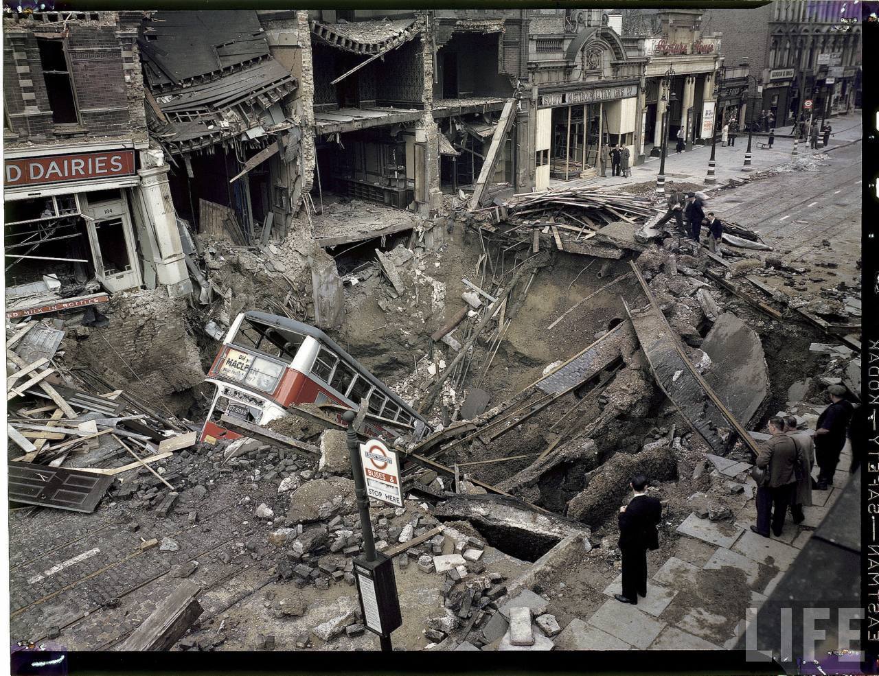 London Bus laying inside huge bomb crater after heavy German air raid bombing attacks