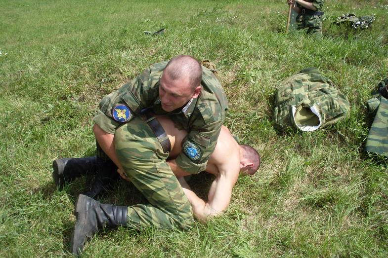 army dudes demonstrating some wrestling moves……… 1 dude took the time to strip off and fold his clothes away……… intimidation started early 4 him!!!