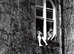 schouler:windsweptribbons:   1950s Student Studies with Feet Out Window.  Students study in their dorm room in Main Building while hanging their legs out of the window. (via pinpricks)   