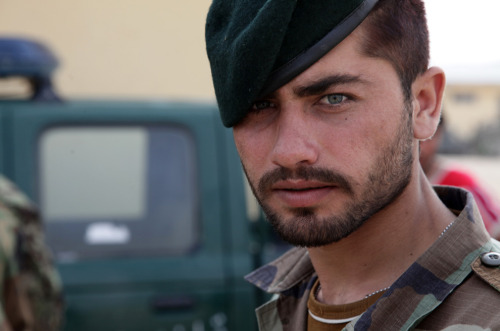 An Afghan National Army soldier looks at the camera during vehicle search training instructed by U.S