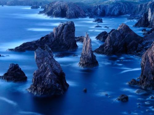 Their crumpled layers as old as the continents, the sea stacks and cliffs of the Outer Hebrides in S