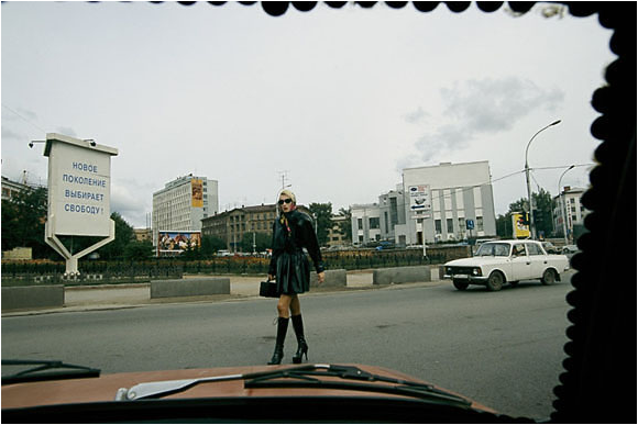 View on the New Russia: A car’s windshield, held in place by coins, frames a woman