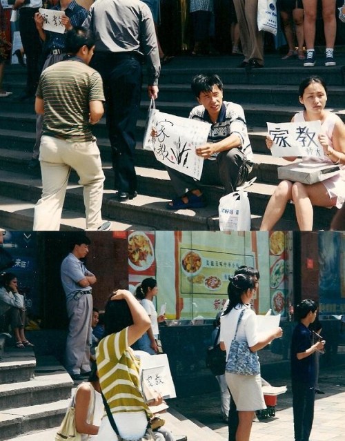 Chinese grad students look for tutoring work, holding signs to indicate their subject areas.