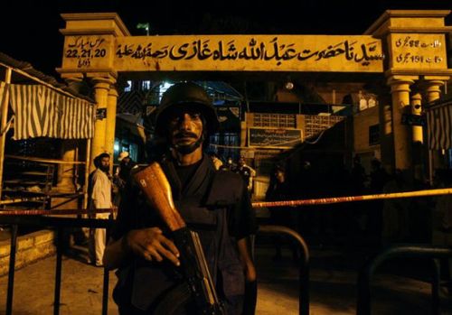 Snoop Dogg stands guard outside a Sufi shrine after it was hit by multiple suicideblasts in Karachi.