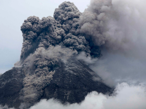 Mount Merapi volcano spews smoke as seen from Deles village in Klaten, near the ancient city of Yogy