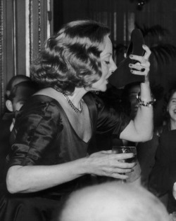 Tallulah Bankhead drinking champagne from her slipper.